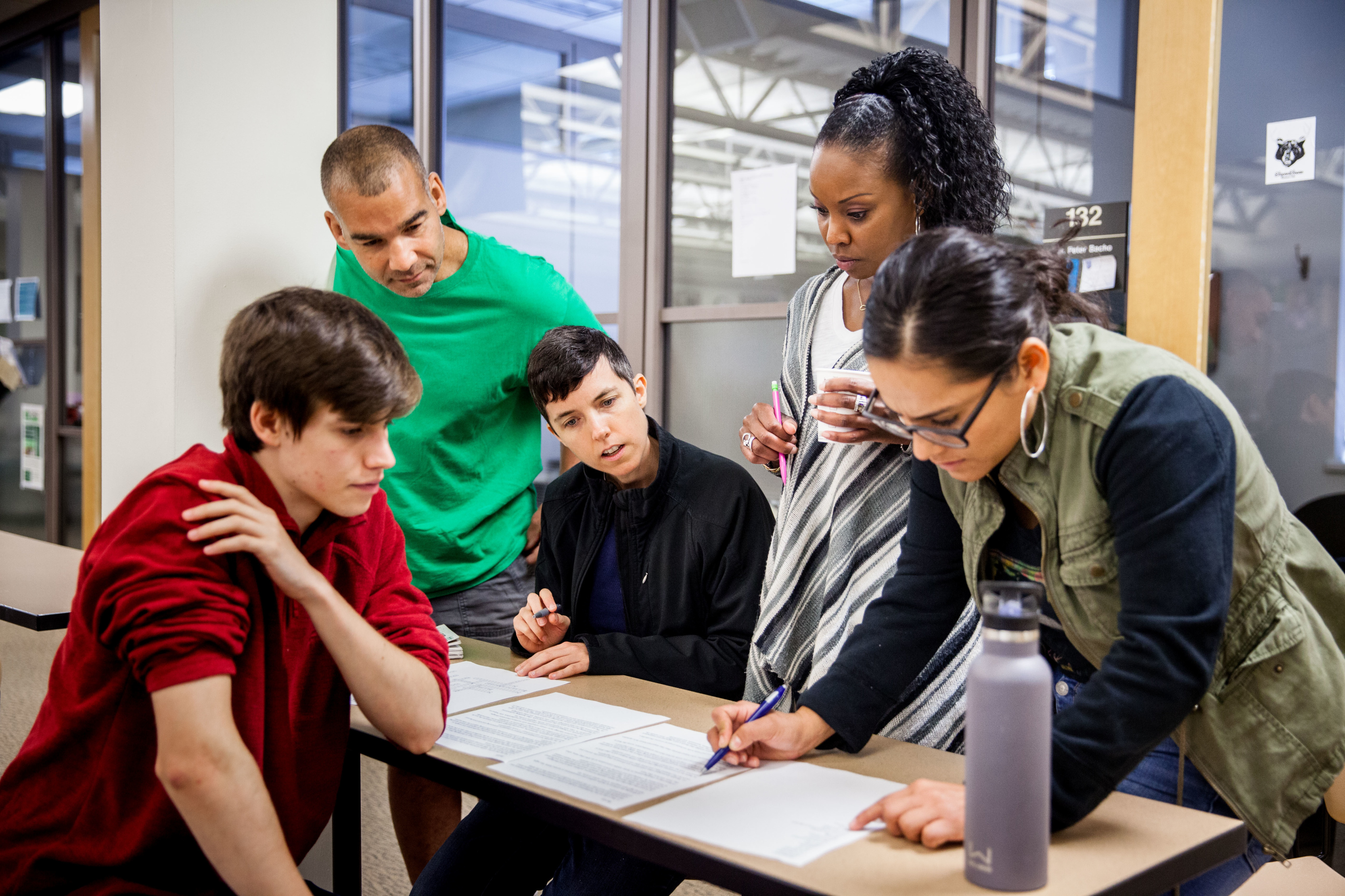 A diverse group of people work together on a project