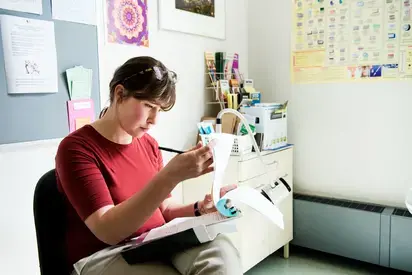 Administrator looking through files in a doctor's office