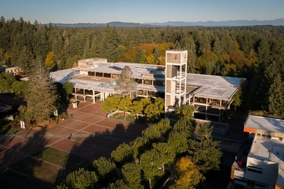 Aerial view of Evergreen Olympia with clocktower in foreground and mountains in background