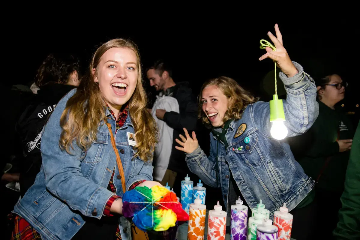 Two students make tie-dye t-shirts at night