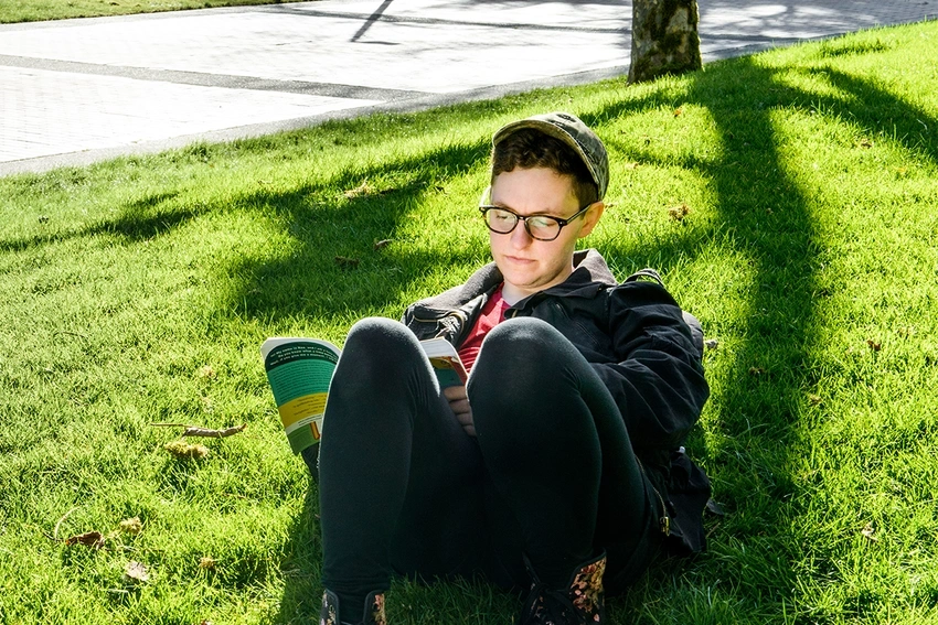 Student reading in the sun