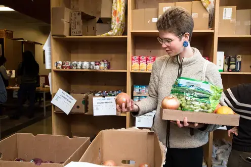 Student shopping for produce at the Evergreen food bank