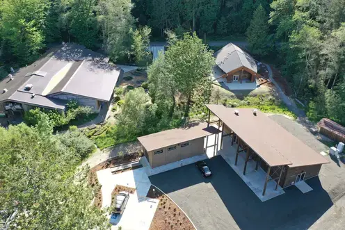 Aerial photo of the four buildings in the Indigenous Arts Camus surrounded by trees.