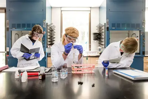 three students participating in the chemistry glow lab